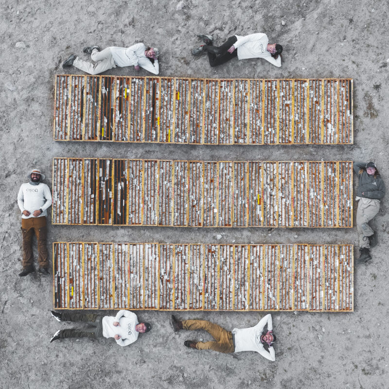 A drone photo of Geologist laying next to boxes of core at the Cisco project