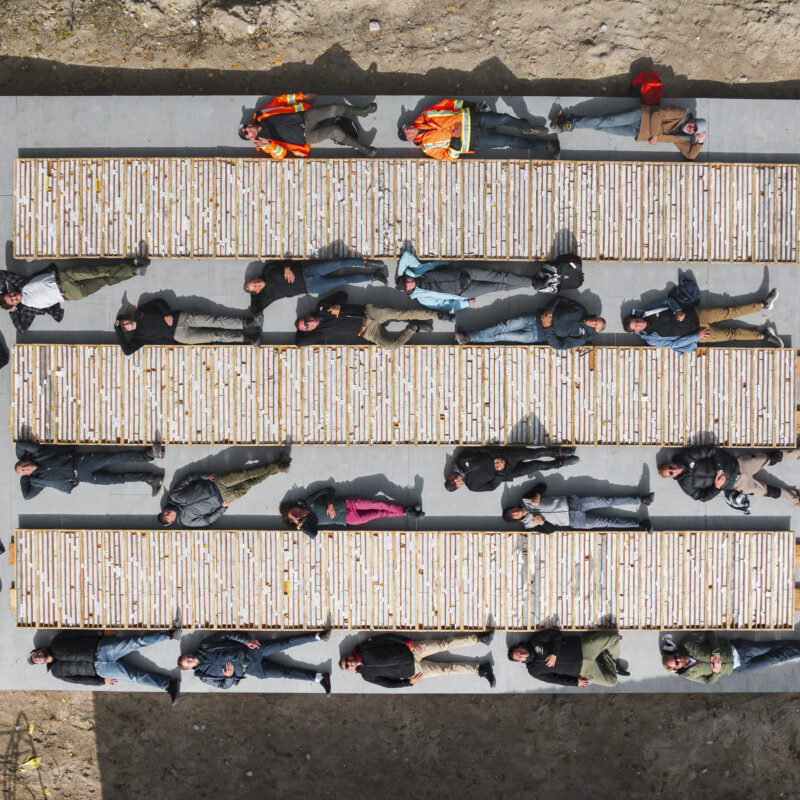 A drone photo of investors laying next to boxes of core at the Cisco project
