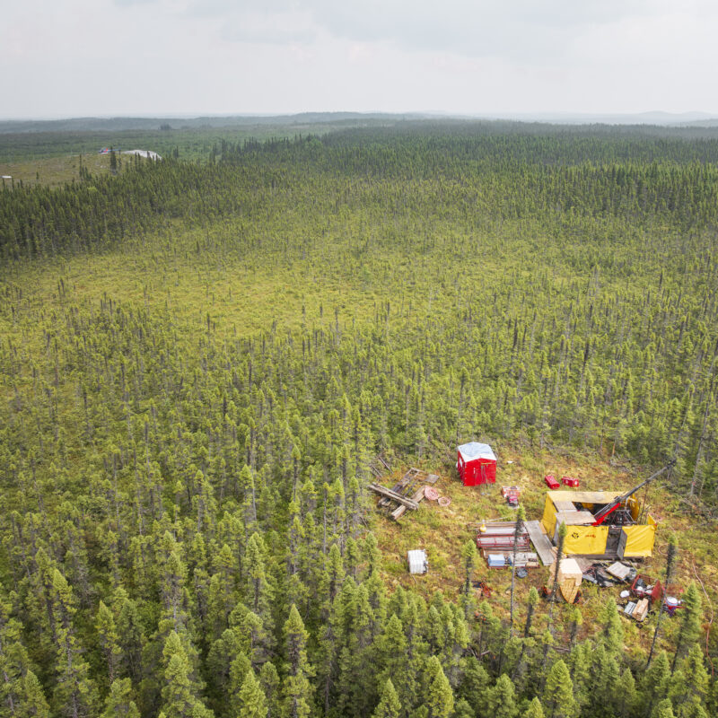 A drone photo of the landscape with a view of a drill and the CO1 outcrop at the Cisco project