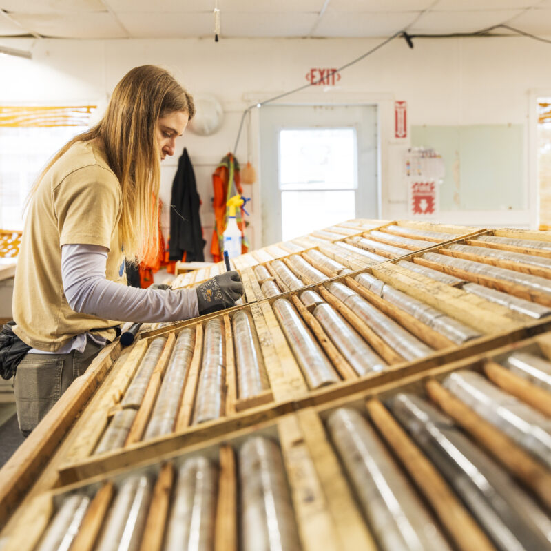 A photo of a geologist logging core in the core shack at the Cisco Project